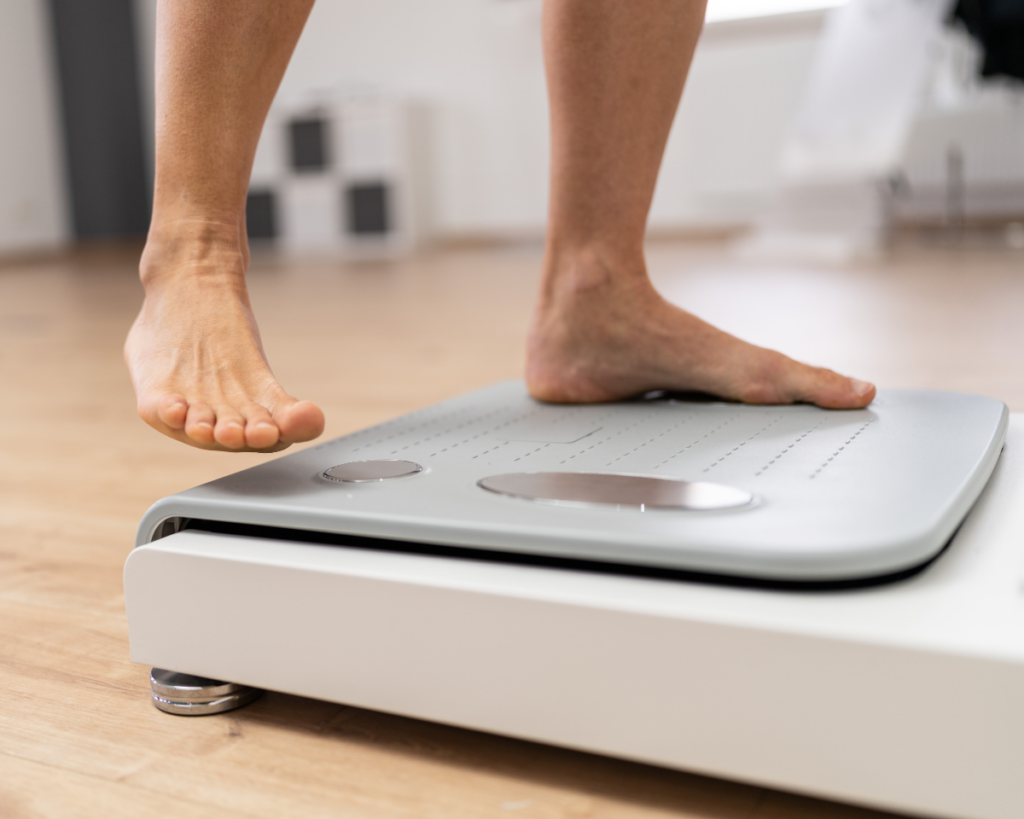 A close-up shot of a patient's feet stepping onto an InBody scale.